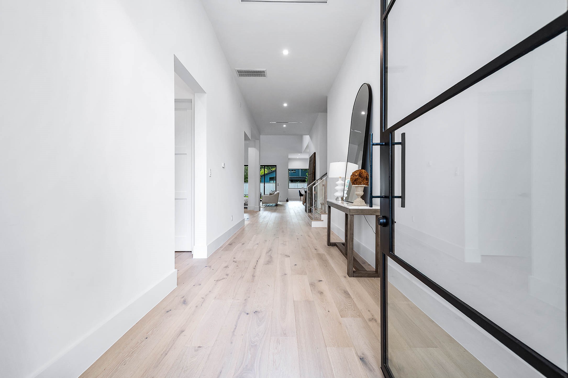207 West 33rd Street Houston, TX 77018 - Photo 3 of 50 Inviting entryway showcasing a striking 9-foot glass door that fills the space with natural light and sets an elegant first impression.