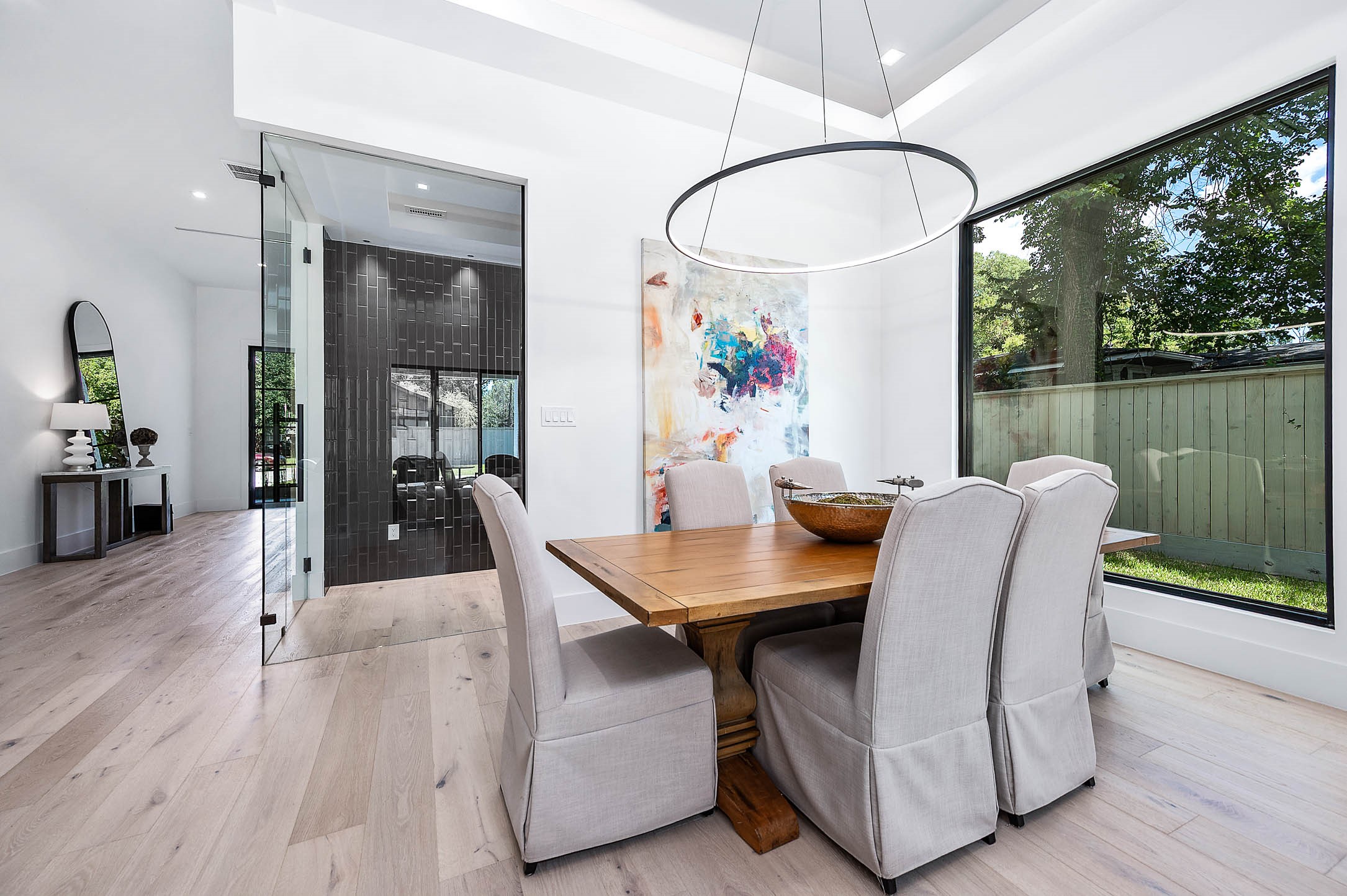 207 West 33rd Street Houston, TX 77018 - Photo 7 of 50 Sophisticated glass-enclosed wine room located just off the dining area, offering a stylish display for your collection and easy access for entertaining.
