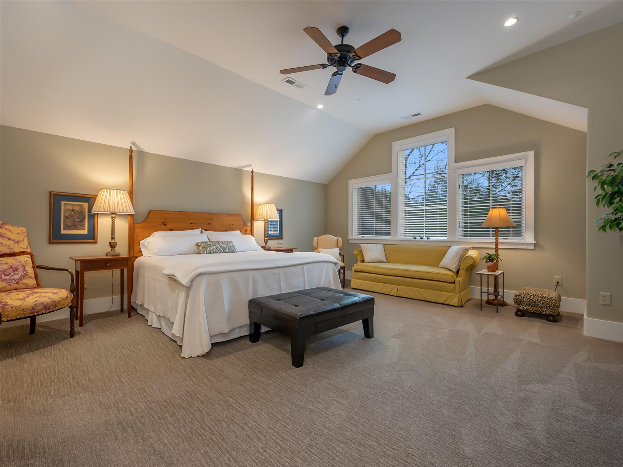 275 Clubhouse, Unit C301 Mill Spring, NC 28756 - Photo 22 of 41 a bedroom with a bed a couch and a ceiling fan