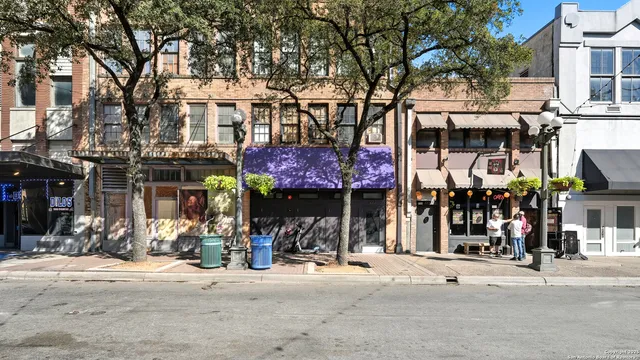 a view of street with shops on a street