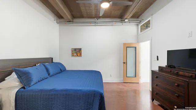 a bedroom with a bed and flat screen tv