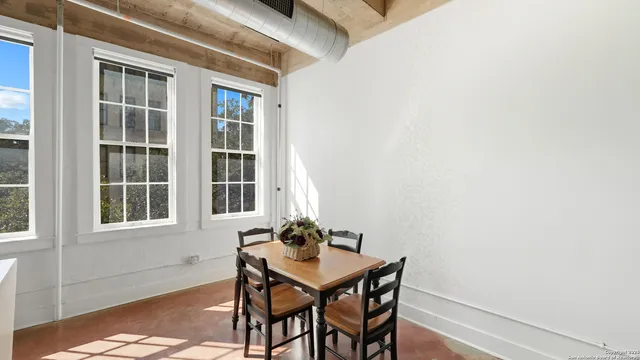 a dining room with furniture and window