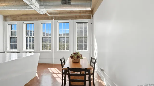 a dining room with furniture and window
