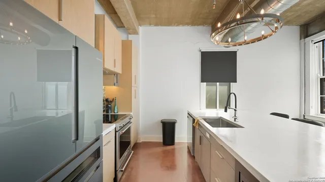 a kitchen with a sink and refrigerator