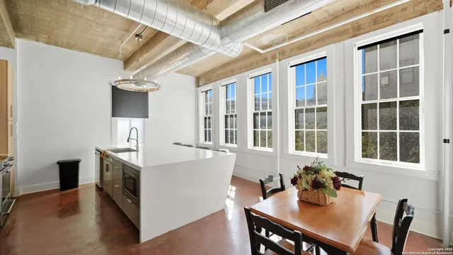 a view of a dining room with furniture and window