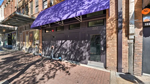 a view of a house with a door and wooden walls