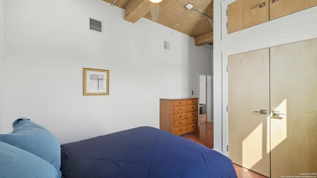 a bedroom with a bed and a dresser