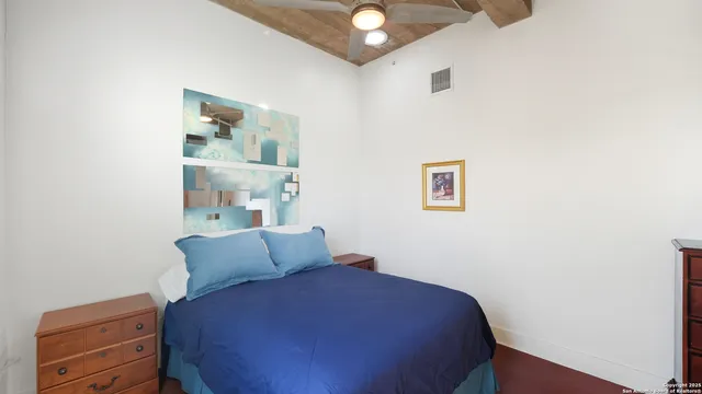 a bedroom with a bed and cabinets