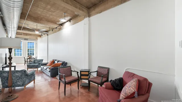 a living room with furniture a couch and wooden floor