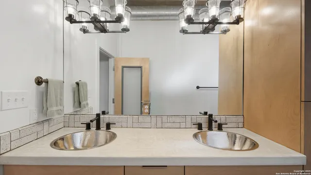a bathroom with a sink a mirror and vanity