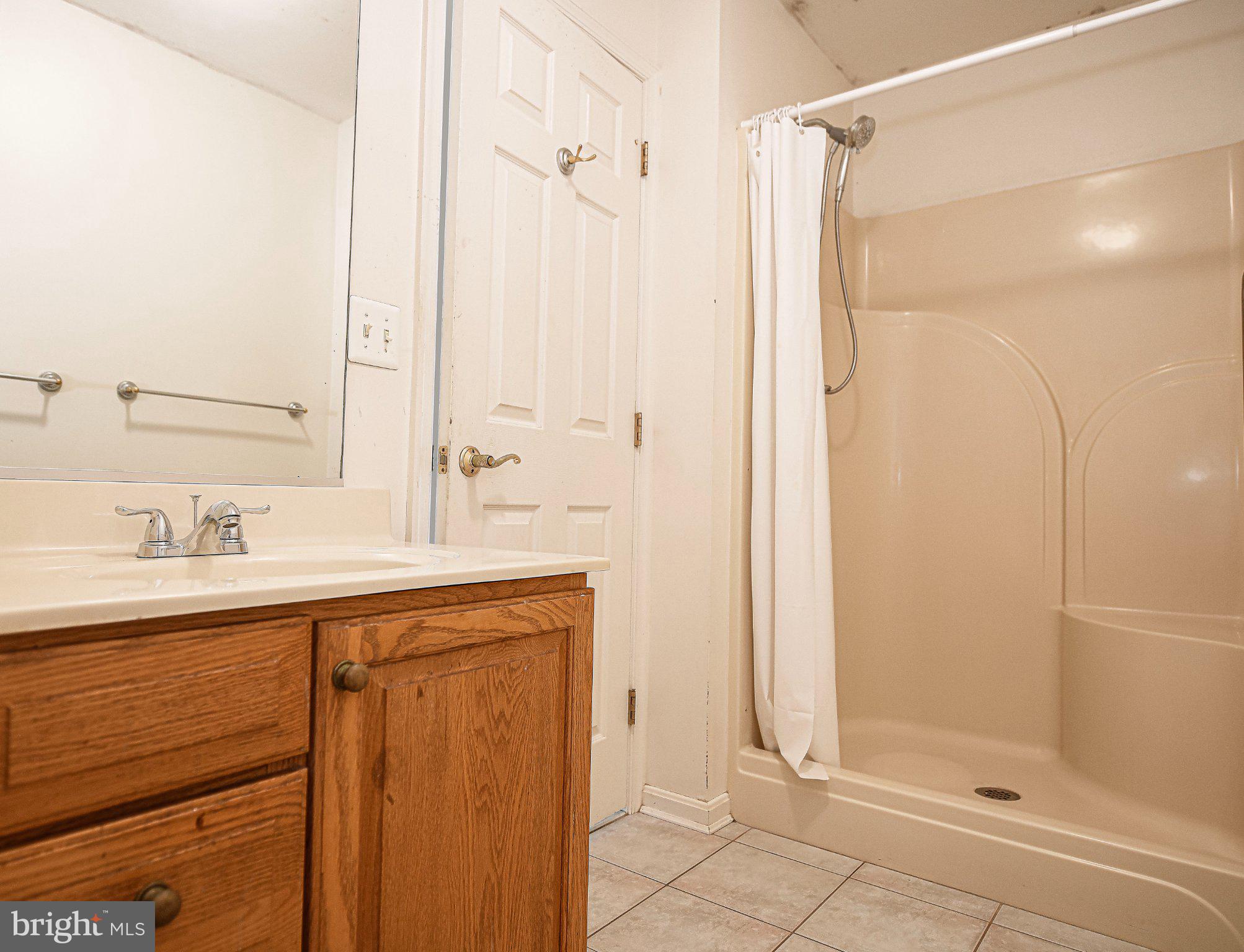 711 Gilbert Road Aberdeen, MD 21001 - Photo 20 of 54 a bathroom with a shower sink and mirror