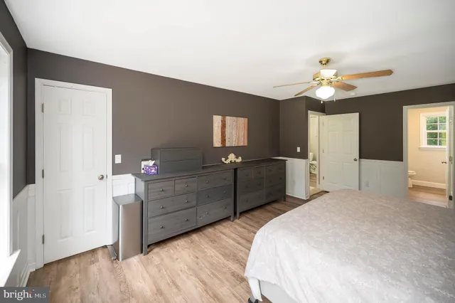 a bedroom with a bed and a mirror