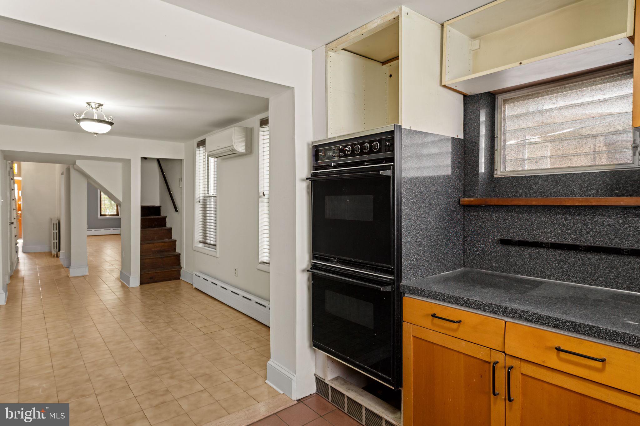 3633 Warren Street Philadelphia, PA 19104 - Photo 15 of 38 a kitchen with granite countertop a refrigerator and a stove