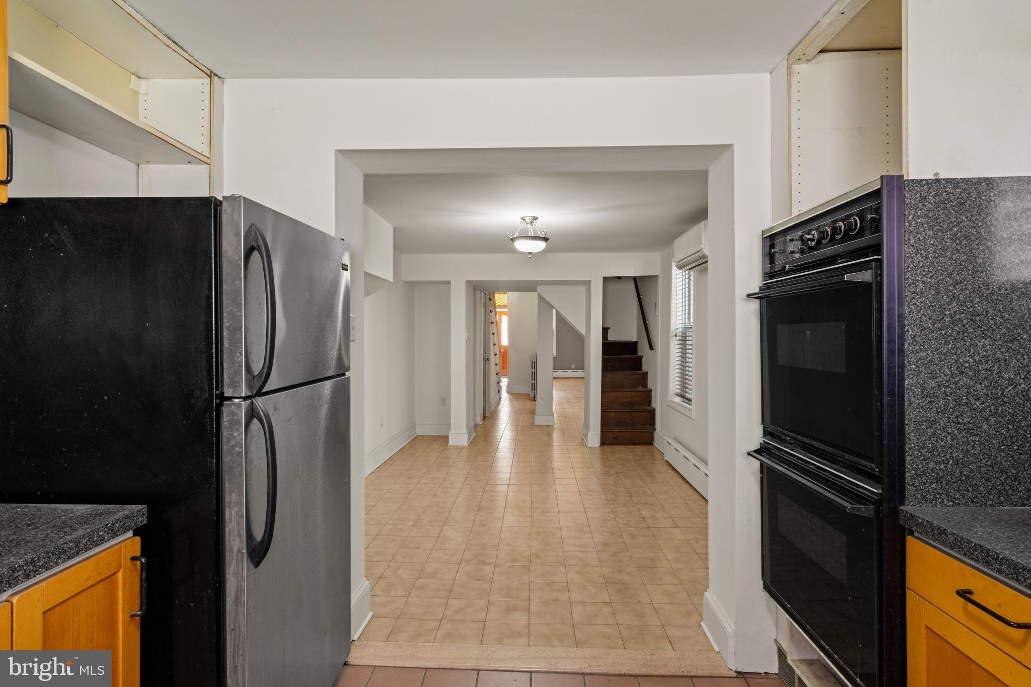 3633 Warren Street Philadelphia, PA 19104 - Photo 16 of 38 a kitchen with a refrigerator and a stove