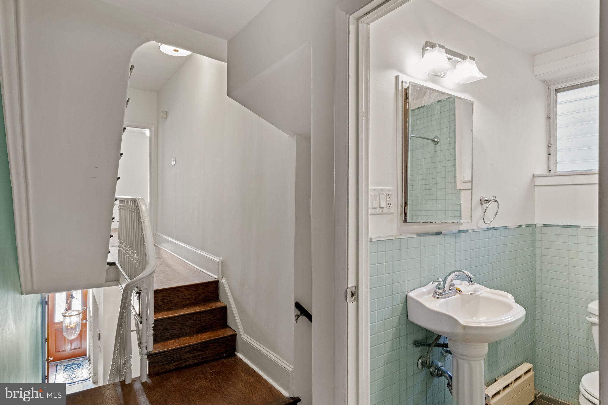 3633 Warren Street Philadelphia, PA 19104 - Photo 18 of 38 a bathroom with a sink mirror and toilet