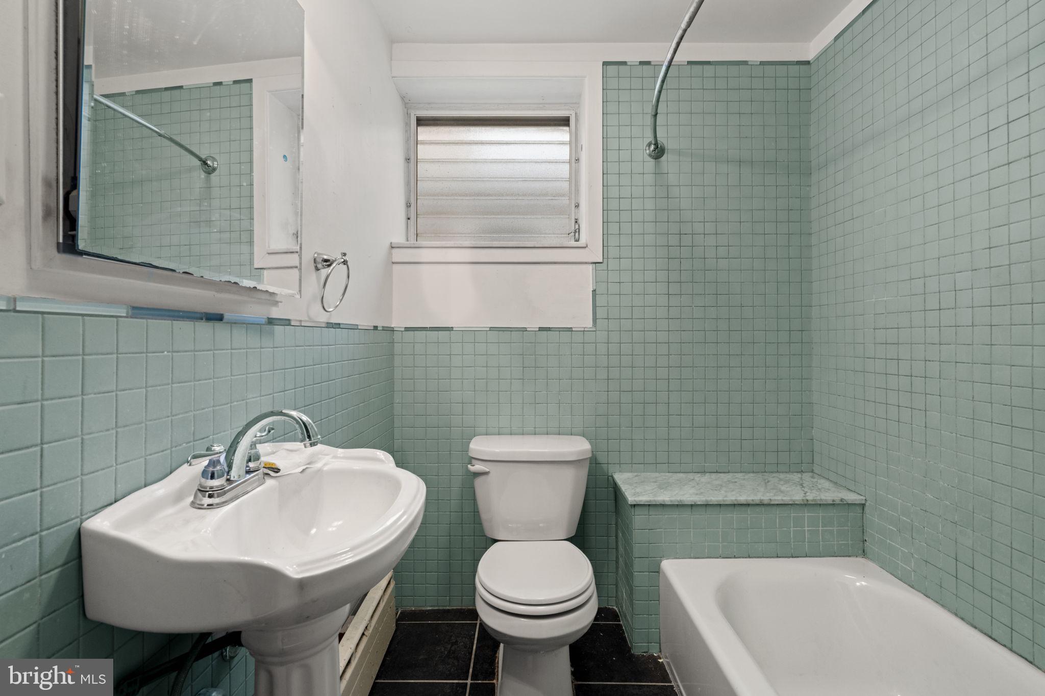 3633 Warren Street Philadelphia, PA 19104 - Photo 19 of 38 a bathroom with a sink a toilet and a mirror