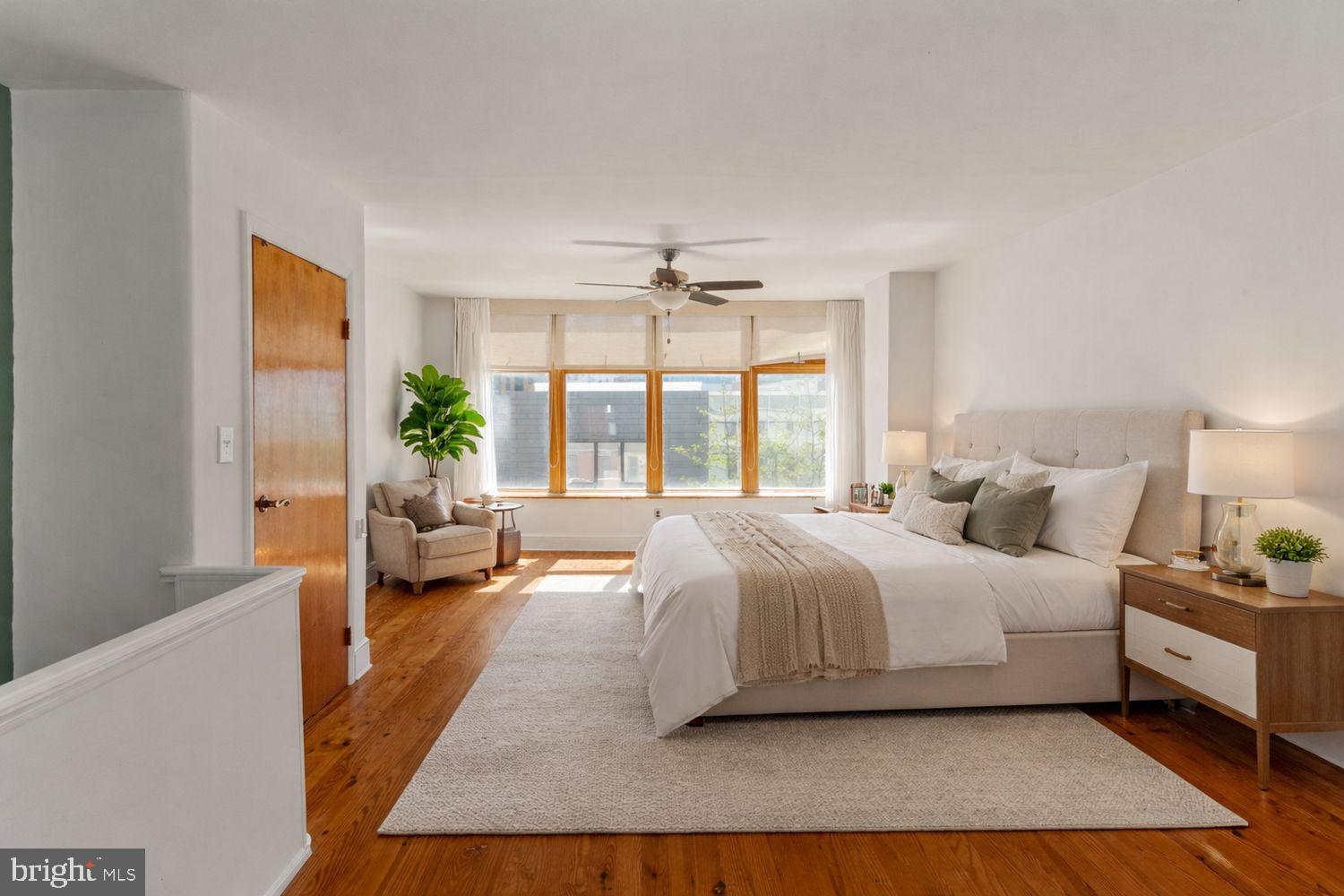 3633 Warren Street Philadelphia, PA 19104 - Photo 31 of 38 a spacious bedroom with a bed a couch and a large window