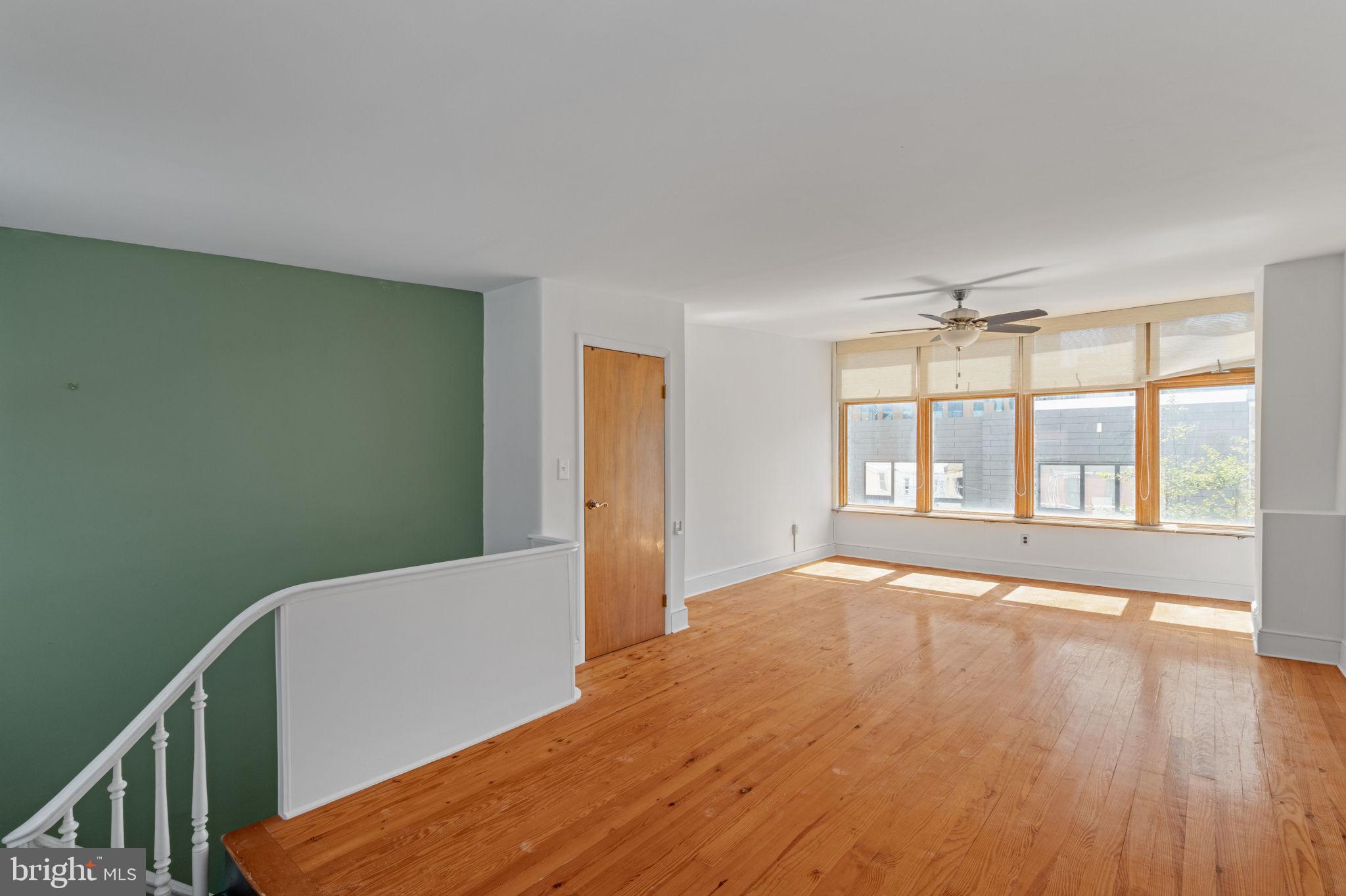 3633 Warren Street Philadelphia, PA 19104 - Photo 33 of 38 a view of an empty room with a window and wooden floor