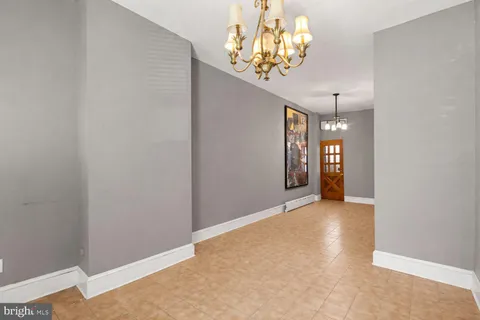 a view of a hallway with windows and chandelier