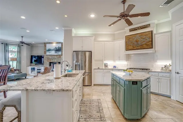 a kitchen with granite countertop a sink stainless steel appliances and cabinets