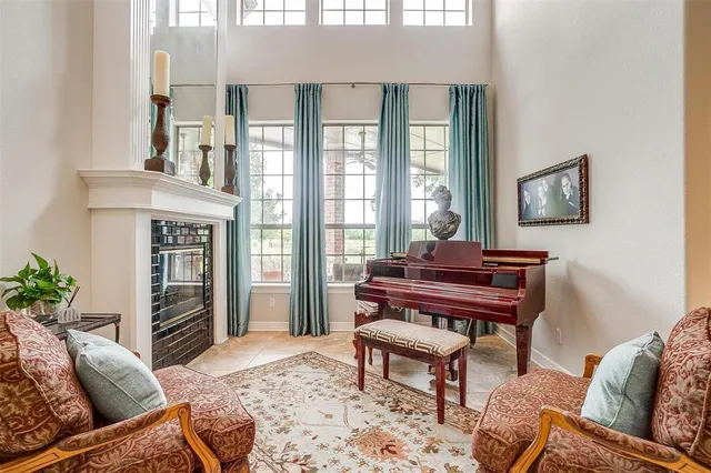 a living room with furniture and a piano