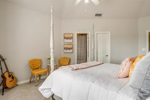 a bedroom with a bed a window and chair