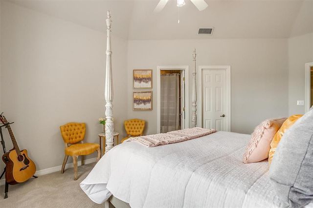 a bedroom with a bed a window and chair