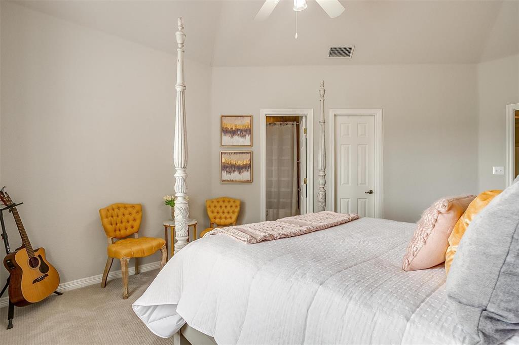 173 Trinity Bluffs Road Aledo, TX 76008 - Photo 27 of 40 a bedroom with a bed a window and chair