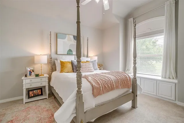 a bedroom with a bed a lamp and window