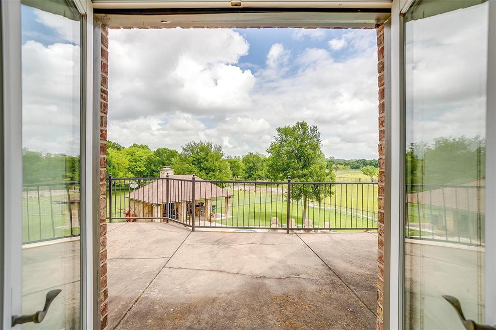 173 Trinity Bluffs Road Aledo, TX 76008 - Photo 35 of 40 a view of a balcony with a floor to ceiling window with wooden fence