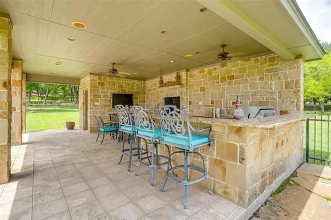 a view of a patio with a table and chairs