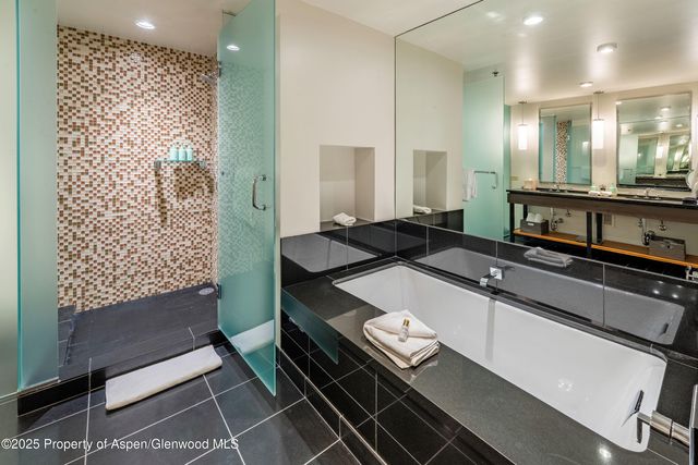 a bathroom with a mirror and a shower