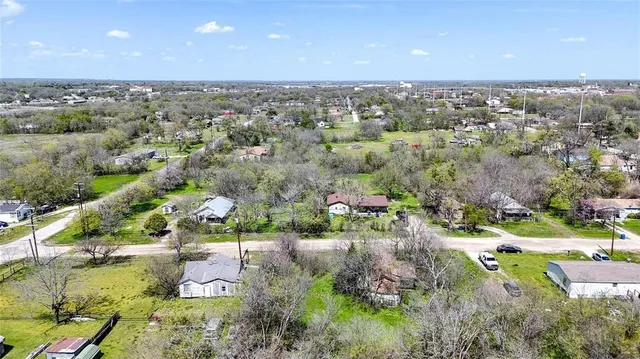 an aerial view of residential houses with outdoor space and swimming pool