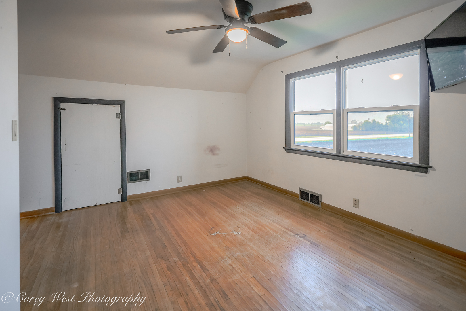 8994 Highway 64 Sycamore, IL 60178 - Photo 26 of 37 wooden floor in an empty room with a window