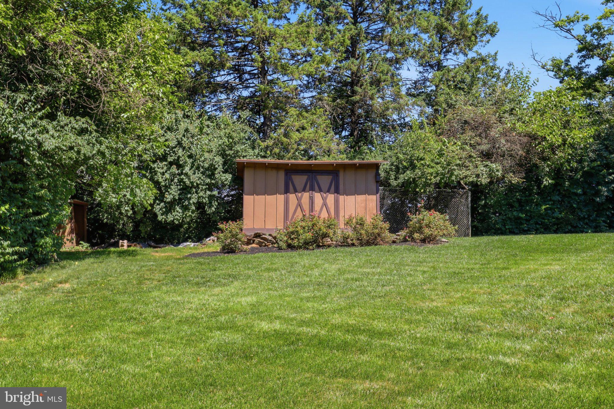 2381 Ridge Road Glenville, PA 17329 - Photo 43 of 58 Charming shed nestled in lush greenery.