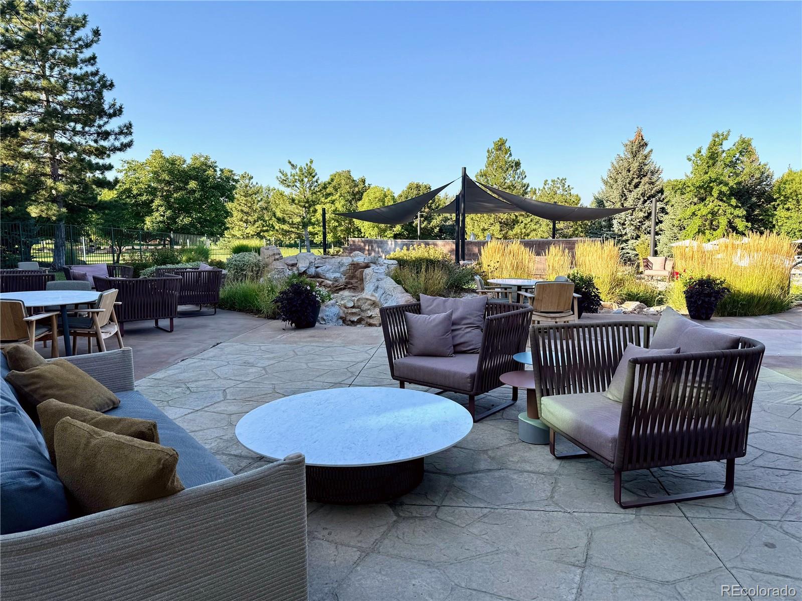 8578 Gold Peak Drive, Unit D Highlands Ranch, CO 80130 - Photo 17 of 50 a view of a patio with couches table and chairs and potted plants