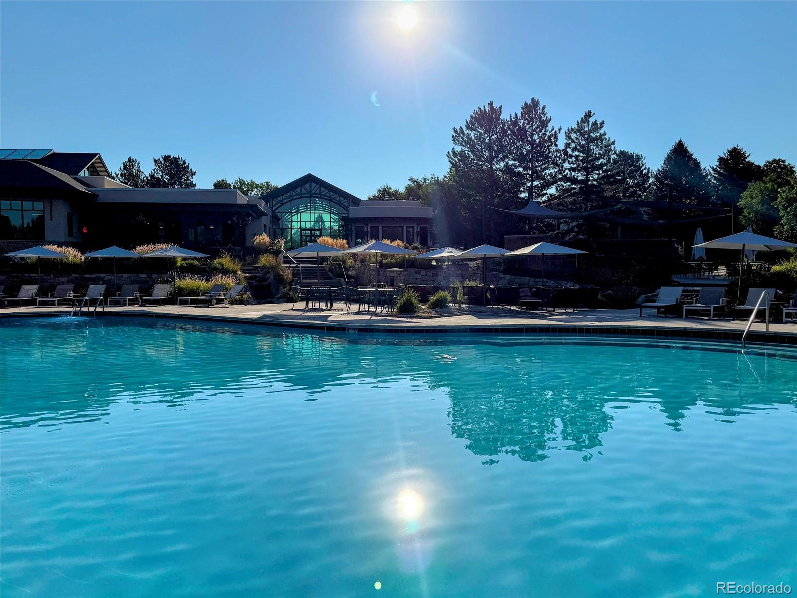 8578 Gold Peak Drive, Unit D Highlands Ranch, CO 80130 - Photo 18 of 50 a view of a lake with a house in the background