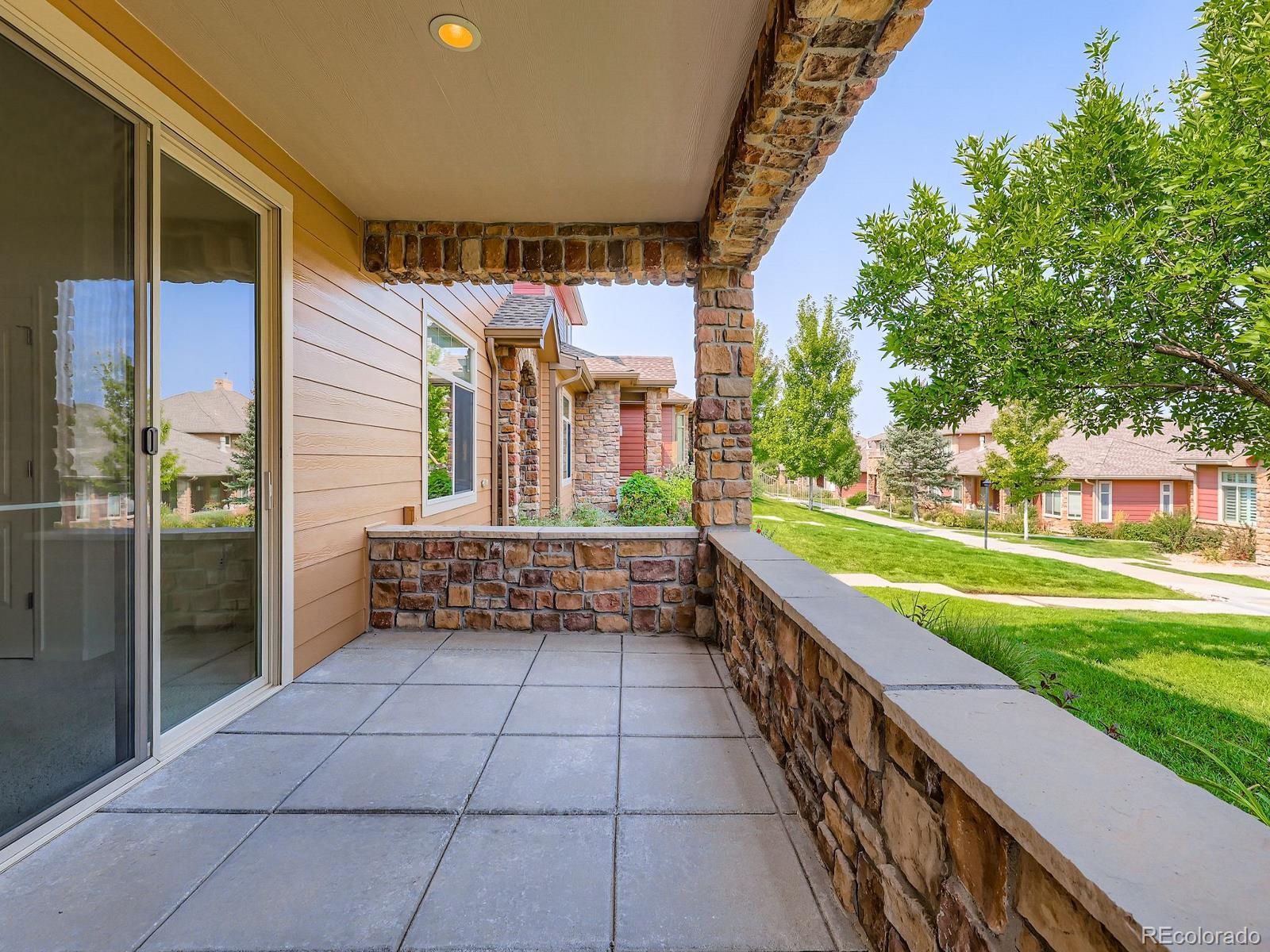 8578 Gold Peak Drive, Unit D Highlands Ranch, CO 80130 - Photo 2 of 50 a view of a porch with furniture and a yard