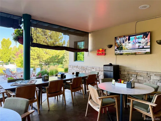 a view of a backyard with sitting area and garden