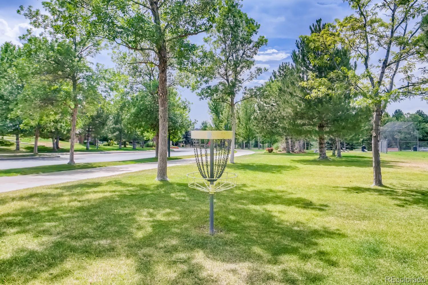 8578 Gold Peak Drive, Unit D Highlands Ranch, CO 80130 - Photo 38 of 50 a swimming pool with lots of tress in front of it