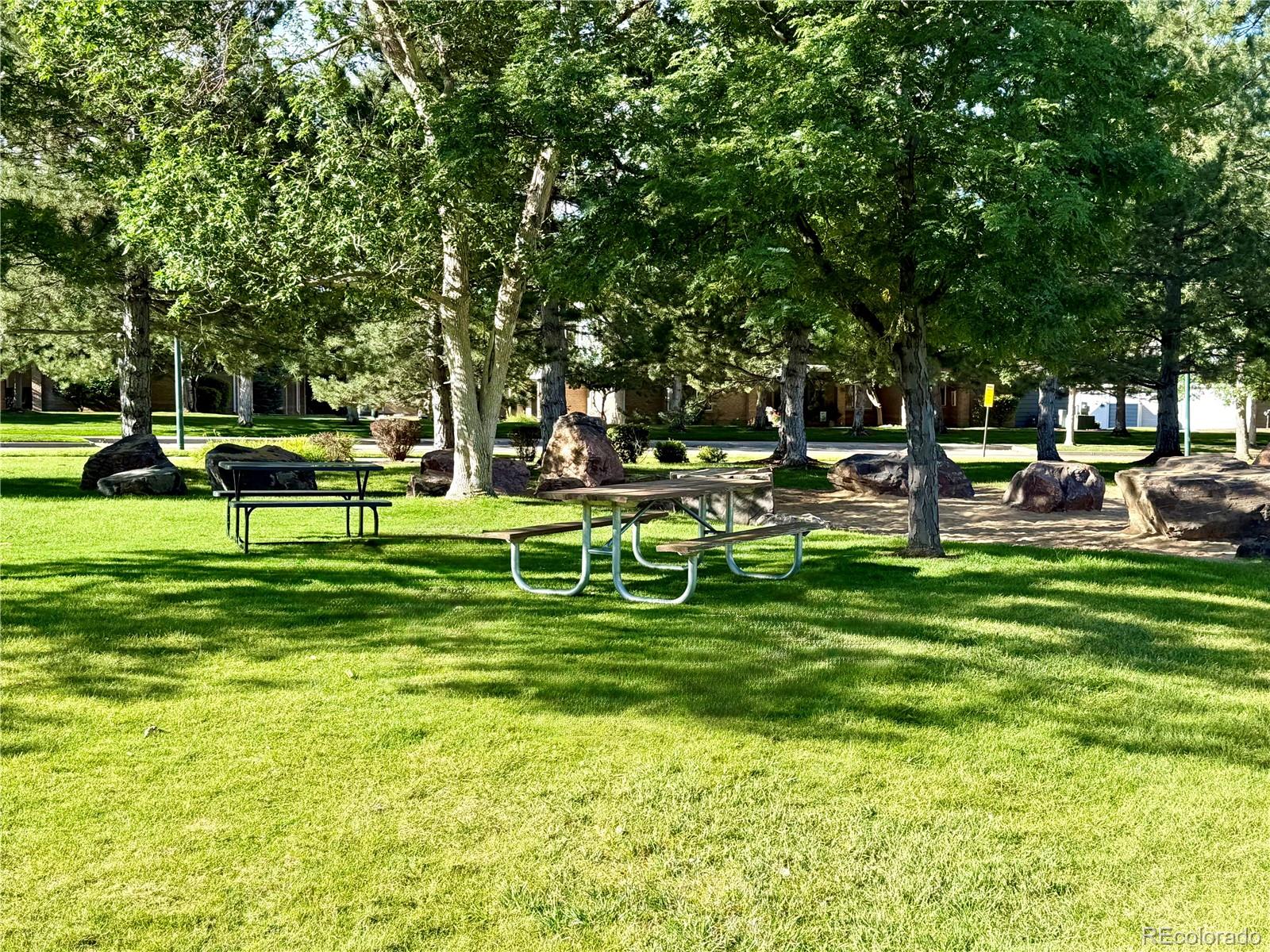 8578 Gold Peak Drive, Unit D Highlands Ranch, CO 80130 - Photo 44 of 50 a front view of a house with a big yard and sitting area