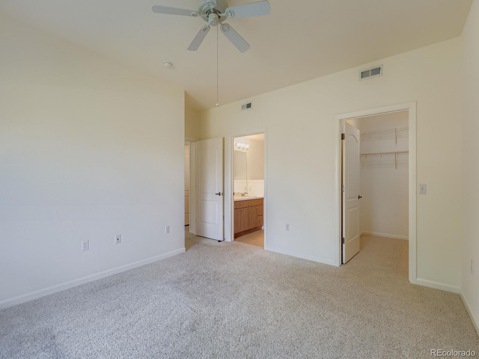 8578 Gold Peak Drive, Unit D Highlands Ranch, CO 80130 - Photo 8 of 50 a view of an empty room and a ceiling fan