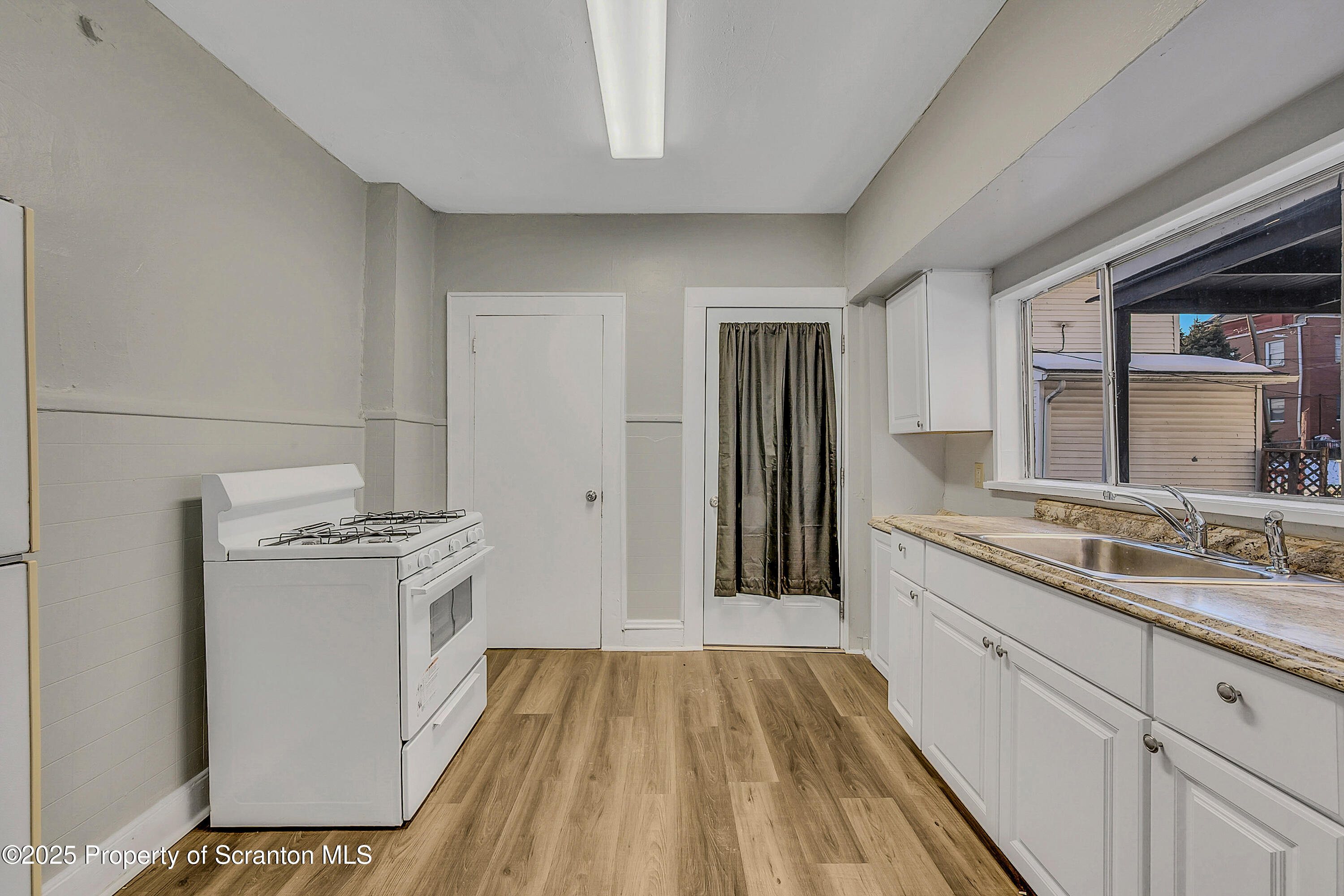 1007 Washburn Street, Unit 1 Scranton, PA 18504 - Photo 9 of 14 a kitchen with a sink stove and refrigerator