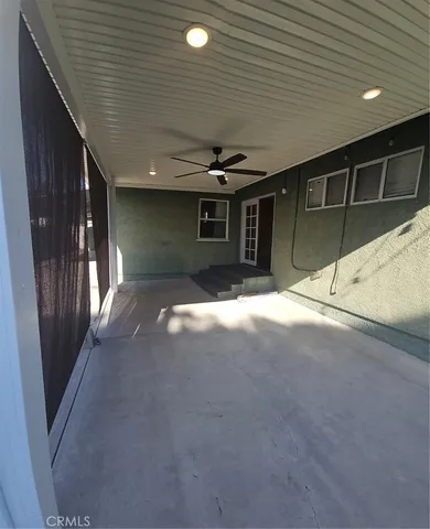 a view of a house with stairs and wooden roof