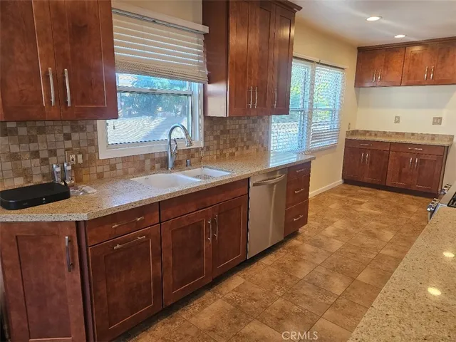 a kitchen with a sink a counter top space and cabinets
