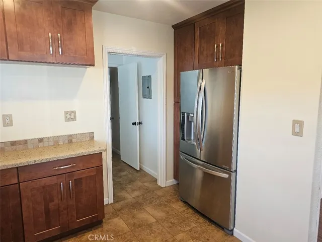 a kitchen with stainless steel appliances granite countertop a refrigerator and a sink