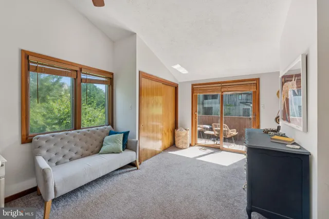 a living room with furniture and large windows
