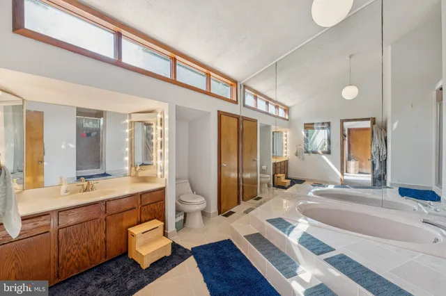 a spacious bedroom with a bed and wooden floor