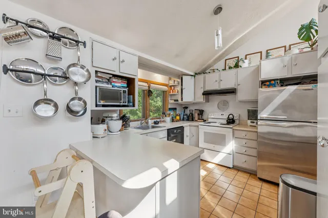 a kitchen with stainless steel appliances granite countertop a sink and cabinets