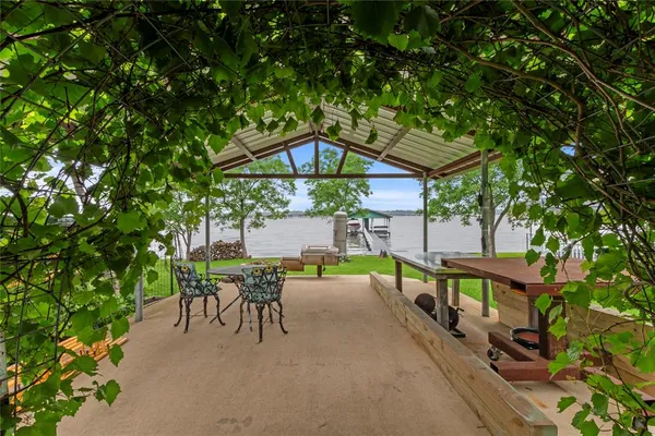 a view of a house with backyard sitting area and garden